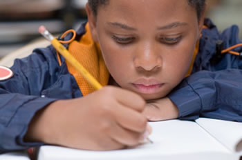 Student having difficulty writing while doing school work, expressing symptoms of Dysgraphia.